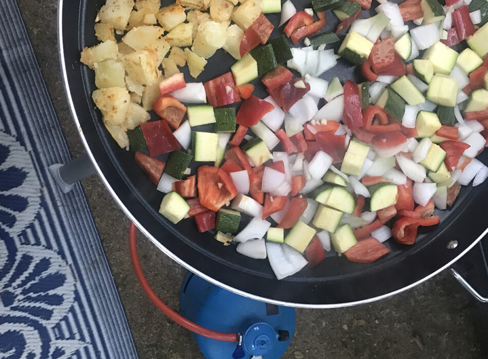 Paella pan Cadac Dometic met daarin groenten en aardappeltjes