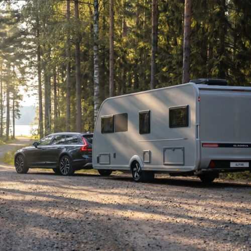 Adria Alpina 583 UL op een weg in het bos met een auto ervoor